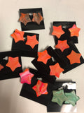 seven pairs of star-shaped wooden earrings 